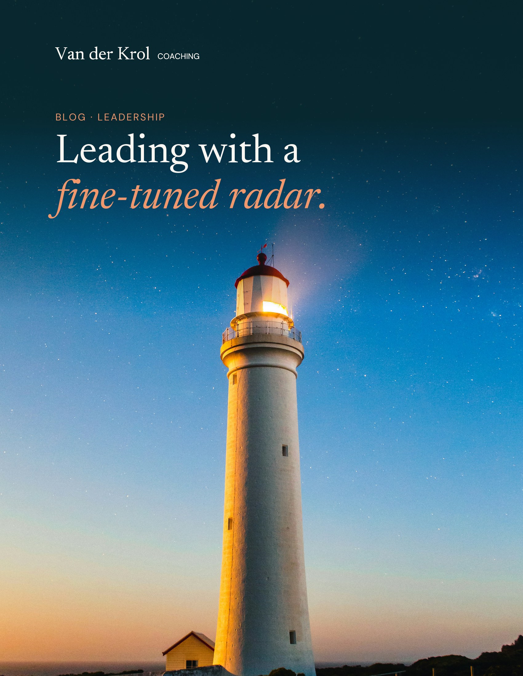A white lighthouse with its light on under a starry sky at dusk